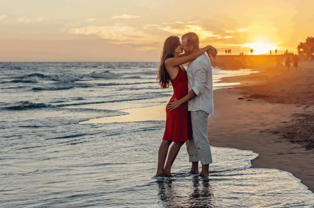 couple-kissing-on-beach-during-golden-hour
